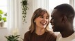 © twilight mist - Happy Young Interracial Couple Laughing and Looking at Each Other in Bright Modern Living Room