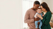 © PhotoArtHub - Family with baby embracing tenderly, representing unconditional love, warmth, and the preciousness of new life, symbolizing heritage and togetherness