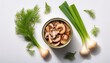 © Kelly - a top down view shows an open tin can filled with sliced canned mushrooms on white background with fresh green onions