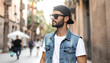© hmm - Stylish man wearing sunglasses and denim vest in urban street, casual fashion, golden hour light, European city vibe