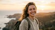© naki - A happy woman with a backpack, enjoying a scenic coastal view at sunset, embracing the spirit of adventure and outdoor exploration