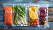 © babon - Assorted fresh ingredients, like fish, vegetables, and citrus fruit, are sealed in transparent vacuum bags for storage