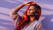 © jambulart - A woman with vibrant red hair, closed eyes, and a relaxed expression, standing against a purple background with soft shadows and lighting, conveying serenity and confidence.