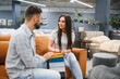 © Serhii - Couple choosing fabric samples for furniture in store