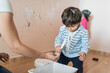 © Antonio Recena - Dirty 2 years old boy helping painting at home