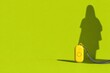 © Leo Rohmann - Yellow personal alarm with human shadow on bright green background
