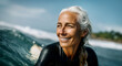 © Prostock-studio - An older woman enjoys surfing the waves on a sunny day, showcasing her skills and love for the ocean. Her smile reflects the joy of the moment while riding the surfboard.