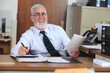 © Connect Images - Man with Muscular Dystrophy in a wheelchair working in an office