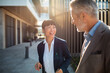 © Davor - Business colleagues talking outside modern office