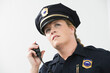 © Connect Images - Woman police officer talking on hand mike