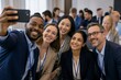 © Kevin - Group of diverse business professionals taking a selfie together at a conference