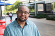 © Connect Images - African American man who has Down Syndrome standing at sidewalk cafaÉa