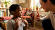 © Rahmat Chowdhury  57 - A young girl and an adult woman communicating with hands in a cozy living room