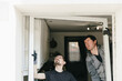 © Nataliya - A close-up portrait of two young Caucasian workers installing a new plastic window frame.