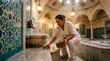 © RedCat - Woman scrubbing marble bench in traditional hammam