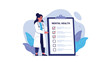 © Simran - Female healthcare professional in a white lab coat standing beside a large clipboard with a mental health diagnostic checklist.