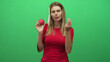 © Krakenimages.com - Woman holding a pomegranate and making a pinched fingers gesture while scrunching her face in studio; skepticism curiosity.