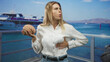 © Krakenimages.com - Woman holding brain model and clutching chest suggesting heartattack on pier by yacht and ocean; concern science education.