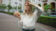 © Krakenimages.com - Woman holding brain aloft with one hand and hand to forehead gesture in street by building; curiosity science education.