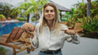 © Krakenimages.com - Woman holding brain model in left hand points finger to brain at building pool deck while making expressive face; curiosity science education.