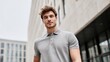 © Serhii - Waist-up portrait of a young man in a gray polo shirt, clean modern fashion look