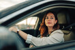 © Zamrznuti tonovi - Woman driving her car, focused on the road, commuting in an urban environment during daytime