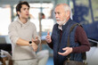 © JackF - Young boss scolds an older employee for being late for work
