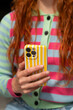 © Alba Vitta Studio/Stocksy - Woman Holds Phone While Wearing Colorful Clothes