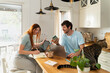 © Alba Vitta Studio/Stocksy - Couple Working Together in Kitchen  in the Morning