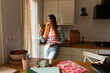 © Alba Vitta Studio/Stocksy - Woman Using Her Phone  in a Kitchen