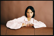© Tania Cervian/Stocksy - Woman leaning on sofa