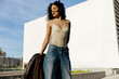 © Tania Cervian/Stocksy - Woman in lace bodysuit and jeans on street