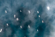 © Bogdan Sinaysky/Stocksy - Boats anchored in the sea in a Calm Sea With Fog in morning, top down