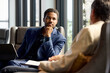 © Guille Faingold/Stocksy - Businessman thoughtful while listening his teammate