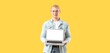 © Pixel-Shot - Smiling young man in denim jacket holding laptop with blank screen, modern technology and digital communication concept, the man presents the laptop