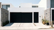 © Waqas - A minimalist urban residence entrance with a black sliding gate and pedestrian door integrated into a sleek white facade, stone-clad side walls, clean paved driveway, contemporary architecture, bright