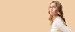 © Pixel-Shot - Blonde young woman with curly hair on beige background