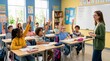 © Julia - Teacher and Elementary School Students Raising Hands in Classroom