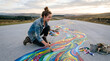 © MM - Empowered young woman painting a vibrant colorful path on an open road, celebrating creativity and freedom