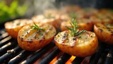 Baby potatoes halved and grilled with rosemary. They steam and sizzle on hot grates with visible embers below. Herbs and spices add aroma to this cooked food.