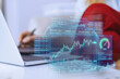 © Westend61 - Financial chart hologram displayed over a business laptop