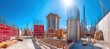 © ЮРИЙ ПОЗДНИКОВ - Construction site panorama with concrete forms, scaffolding, and building framework under blue sky