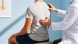 © Victoria - chiropractor examining back of male patient. Doctor checking spine and posture of man. Professional medical consultation, physical therapy session and treatment in healthcare clinic