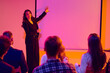 © Lustre Art Group  - Presenter explaining ideas beside projection screen to seated audience. Concept of corporate presentation, seminar coaching, business education, teamwork and communication skills.