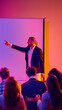 © Lustre Art Group  - Male speaker pointing at blank screen during business seminar with audience. Concept of corporate presentation, training workshop, leadership coaching, public speaking and professional communication.