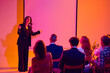 © Lustre Art Group  - Confident businesswoman leading workshop in front of blank screen. Concept of team training, conference session, leadership development, business communication and seminar learning.