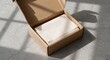 © HanJe - Open cardboard shipping box with white tissue paper on concrete