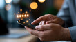 © Kateryna - A close up of a European hand uses softly a calm smartphone with glowing review rating reaction icons in a moody office customer feedback faceless detail softly