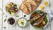 © Raka - Delicious Mediterranean meal with grilled fish, fresh salad, olives, and pita bread