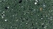 © MDBAKHTIAR - Deep green granite stone texture with black white and gold mineral flecks for background.